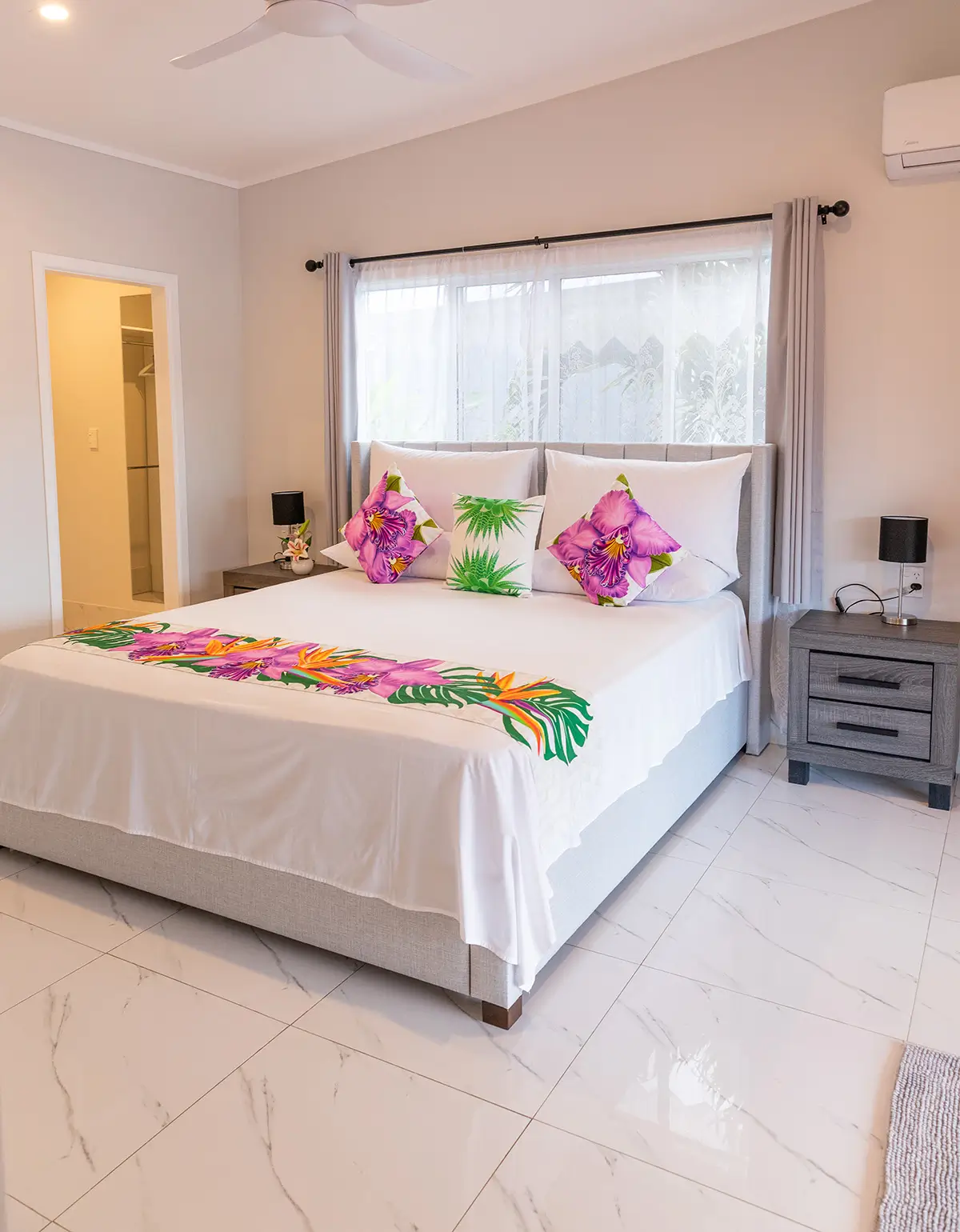 bedroom at Itimarama Villas showing kind size bed with tasteful furnishings